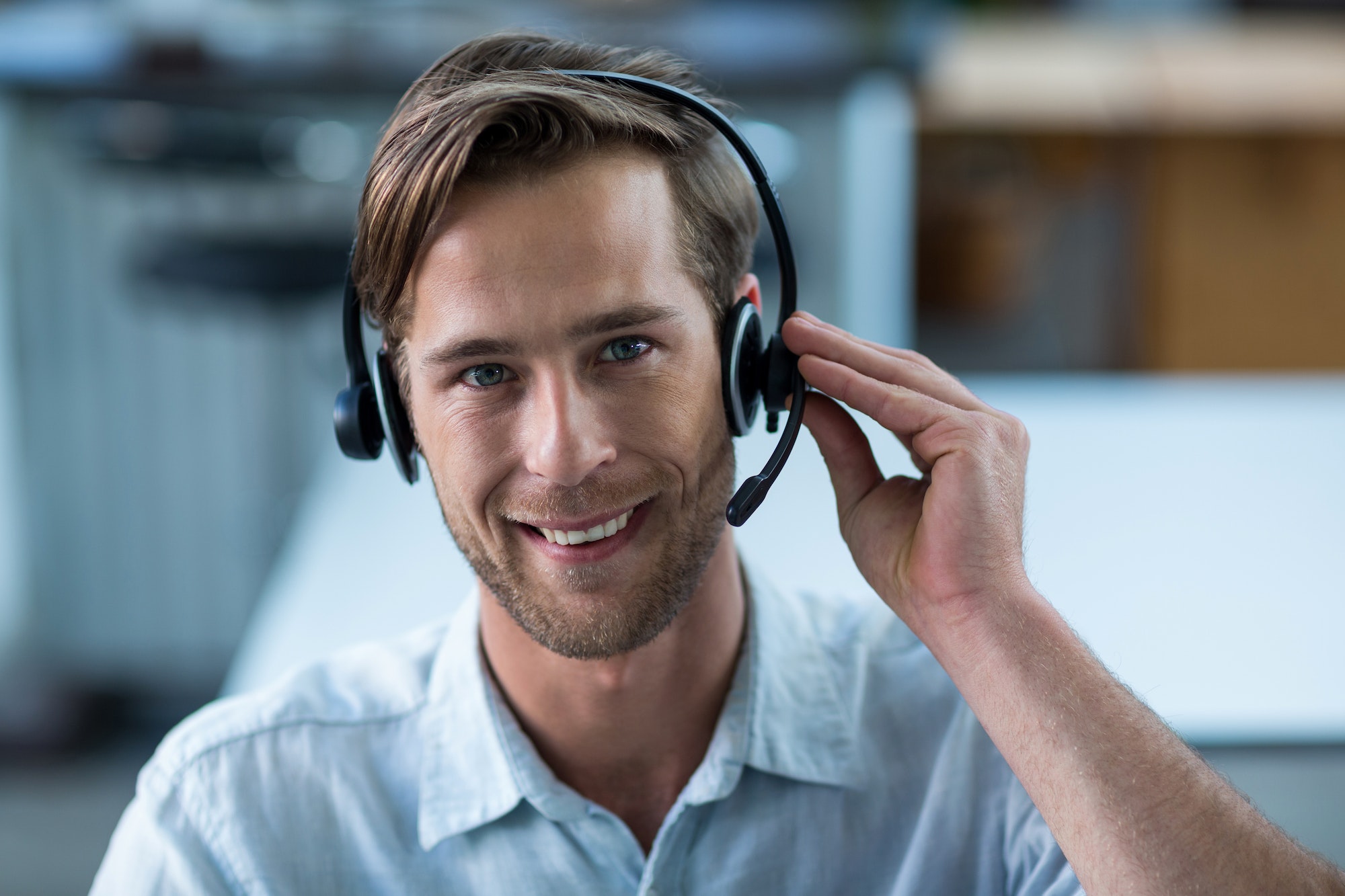 Business executive with headsets in office