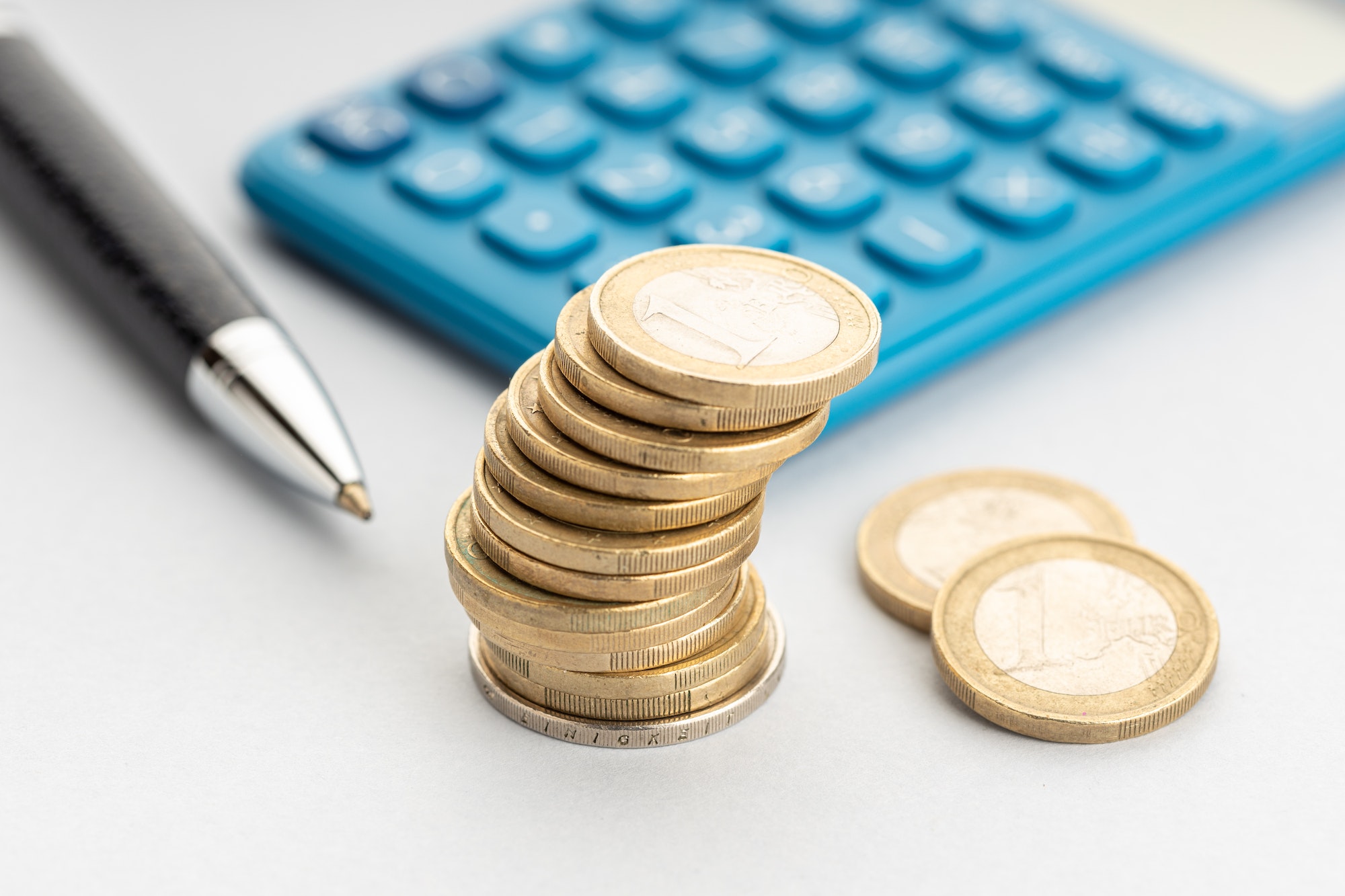 Euro money and calculator on table