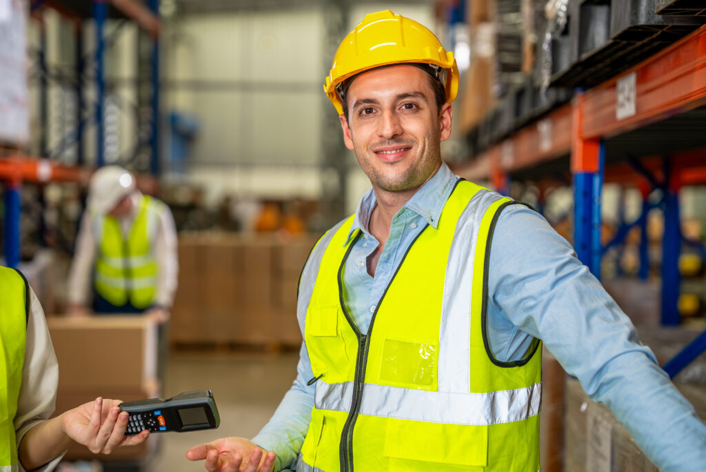 Warehouse workers talking together checking goods in storage