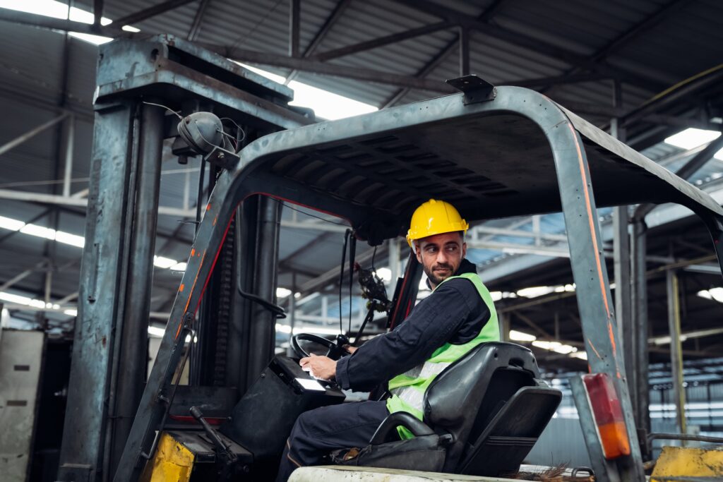 Industrious Engineer Operating Forklift in Warehouse. Efficient Forklift Driving in Factory.