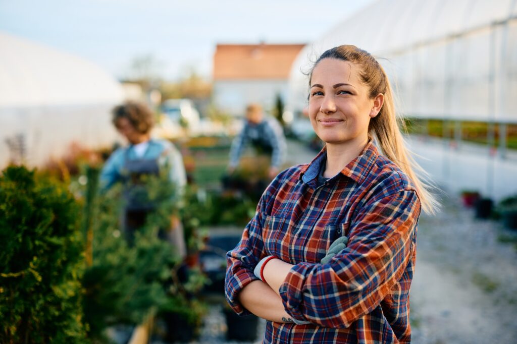 Oferty pracy w Holandii 4 Confident small business owner at her greenhouse looking at camera.